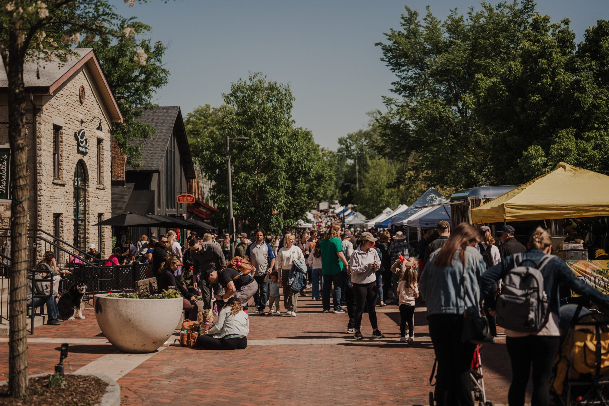 Batavia residents walk along the vendor stands at the Batavia Farmers market right outside of the Geneva Winery.