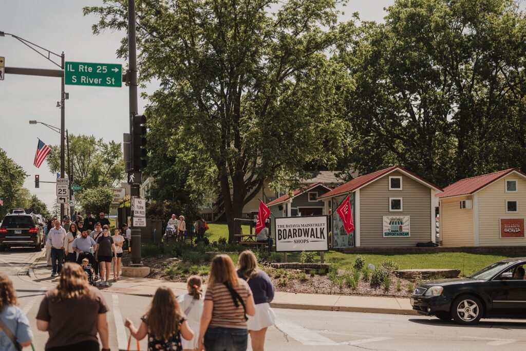 People cross the Illinois Route 25 to shop at the Batavia Boardwalk Shops in Batavia Illinois.